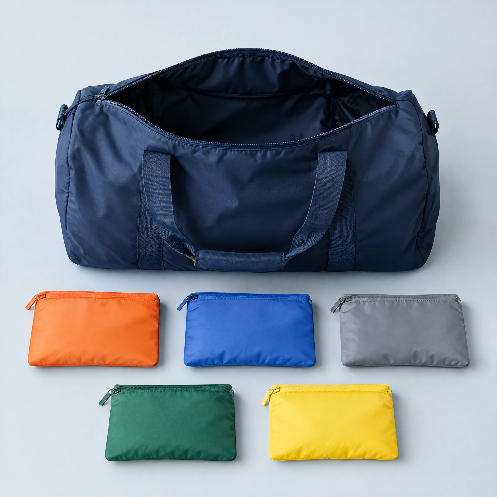 Open navy duffel bag beside five color-coded zip pouches